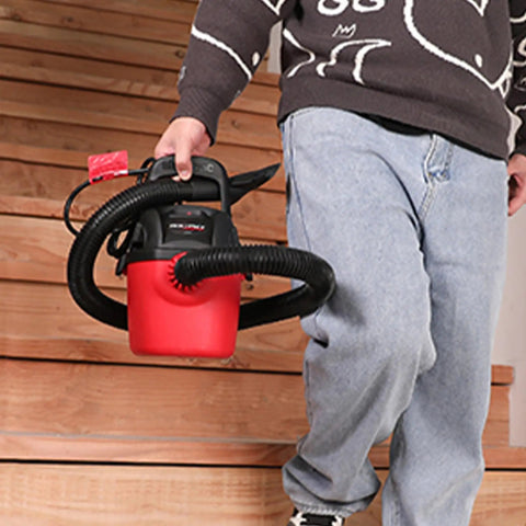Person carrying Tiny But Mighty One Gallon Wet Dry Vacuum With Fold Down Handle And Wall Bracket for quick cleanups