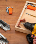 Undermount Drawer Drilling Guide Pro Kit with aluminum drill angle guide, steel inserts, drill bits, and yellow drill in use