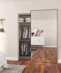 Badass Quality Mirrored Sliding Barn Door Featuring Slick Steel Construction And No Fuss Soft Close Track Designed For Easy Home Makeovers With Prime Cut Safety Backed Glass Pane in a modern bedroom with a closet.