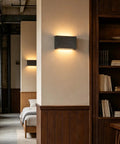 Modern Wood LED Linear Wall Sconce, Mini Up Down Wall Mount Light, Hardwired, UL Listed illuminating a wall in a bedroom.