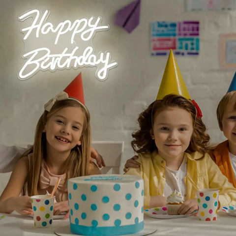 Happy Birthday Neon Sign Dimmable LED Light For Backdrops And Party Decor above kids in birthday hats with polka dot cake.