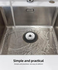 Rubber Bathtub Drain Plug with Stainless Steel Easy Pull-Out Stopper in a stainless sink with flowing water.