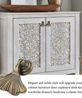 Ginkgo Leaf Knob Handles Six Pack Antique Brushed Bronze Pendant Pulls on a white decorative cabinet
