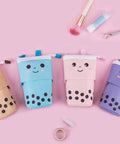 Pop Up Telescopic Pencil Case And Pen Holder Stand Up Transformer Organizer With Adjustable Height Retractable Design For Desk Or Bag Great For Christmas New Year Office Gifts And Easy Cleaning shown in four colors on pink background