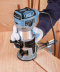 Compact Wood Router With Fixed Base And Edge Guide For Precise Edges, 6.5 Amp Power, 1.25 HP in use on wood surface