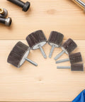 Six pieces of Super Cool 12 Piece Cylindrical Flap Wheel Set for Metal Die Grinding and Polishing Tasks on a wooden surface.