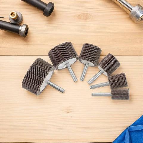 Six pieces of Super Cool 12 Piece Cylindrical Flap Wheel Set for Metal Die Grinding and Polishing Tasks on a wooden surface.