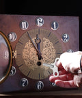 Person using Gearhead Favorite Wrench Clock Key For Winding Mechanical Clocks, 4.4mm Hole, 52mm Long Steel Key in wooden clock
