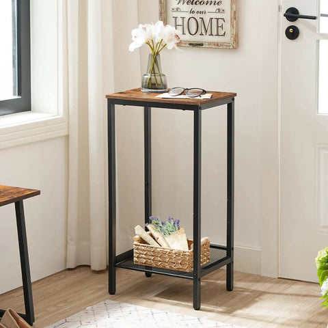 Built Tough Industrial Tall Side Table Featuring Adjustable Mesh Shelves And Rugged Steel Frame Works Like A Charm As A Tall Nightstand For Your Rustic Brown Living Room Setup, showcasing a flower vase and glasses.