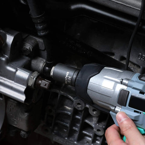 Close-up of Fourteen Piece External Star Impact Socket Set With Storage Case for E4 Through E24 Sockets in use on motor