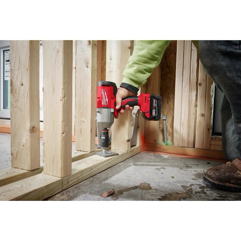 Person using half inch brushless impact wrench with RedLink Intelligence in construction setting, showing high torque power