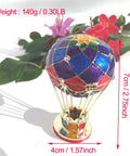 Totally Vintage Enamel Hot Air Balloon Jewelry Box With Rhinestones next to red flowers, eco-friendly decorative trinket storage.