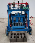 Heavy Duty Concrete Block Making Machine For Industrial Brick Production with finished concrete blocks in front.