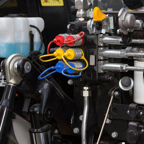Front view of 1/2-inch flat-face hydraulic dust caps and plugs set; red, yellow, blue caps on connectors