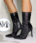 Side view of black knee-high boots with silver 8 mm bullet spike studs along edges and seams; inner side zipper