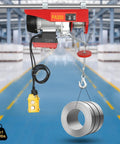 650 Watt Electric Cable Hoist 660 Lbs Capacity With Wireless Remote Control lifting steel coils in warehouse setting.