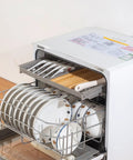Skip the Sink Fully Automatic Desktop Dishwasher For Home Kitchen Large Capacity Auto Wash System With Triple Filter And Front Loading Design Easy Setup Plumbing Free Hands Off Cleanup Routine with dishes in rack.