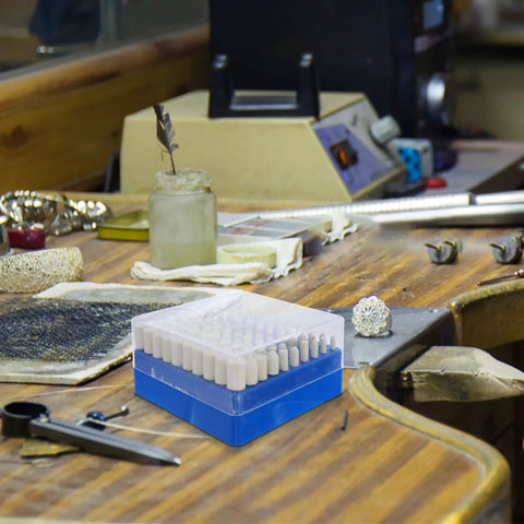 Super Cool 100 Pc Wool Polishing Wheel Kit With 3Mm Shank Box Set on a workbench, showing beige buffing pads in neat box.