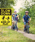 Two Pack Kids At Play Signs For Street With Metal Stakes Double Sided 16 By 12 Inch Children At Play Safety Signs installed on pathway