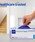 Medium Nitrile Exam Gloves, 300 Pack, Powder Free And Latex Free, hand pulling gloves from box for caregiving tasks.
