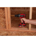 Person using 20V Hypermax Cordless Drill Driver Kit with Half Inch Chuck on wooden frame, showing all metal gear construction