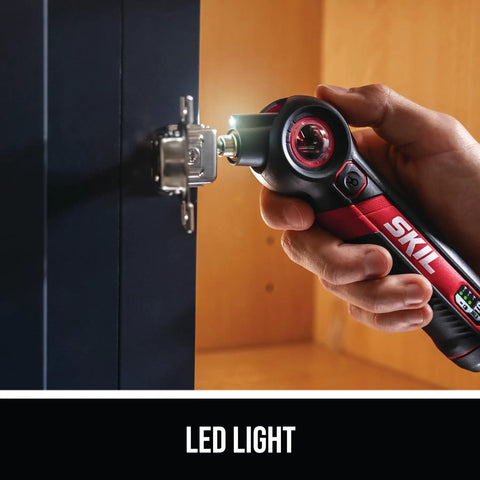 Person using Rechargeable 4V Screwdriver With Pivoting Head For Tight Spaces with LED light to adjust cabinet hinge.