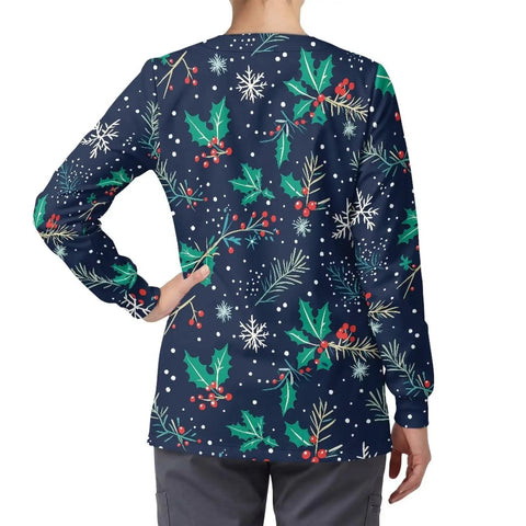 Back view of Christmas Holly Womens Snap Front Scrub Jacket in stretch fabric with festive holly print, long sleeves, worn by a woman