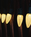 Close-up of warm glowing LED string lights hanging on a dark wood background, showcasing 108 Ft Outdoor String Lights With Remote LED G40 Globe Bulbs Shatterproof 4 Modes Waterproof Connectable Patio Lights For Backyard Deck Perfect For Any Outdoor Vibe.