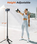 All In One Phone Tripod And Selfie Stick With Remote For iPhone And Android Ultra Portable And Lightweight 62 Inch Extendable Travel Stand shown extended beside a person outdoors.