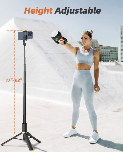 All In One Phone Tripod And Selfie Stick With Remote For iPhone And Android Ultra Portable And Lightweight 62 Inch Extendable Travel Stand shown extended beside a person outdoors.