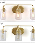 Gold Vanity Light With Seeded Glass Three Light Bathroom Fixture Modern Design for damp or dry locations, shown lit and unlit.