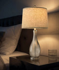 24.5 Inch Glass Table Lamps Set Of 2 With USB Charging Ports on nightstand, illuminating bedroom with modern silver finish