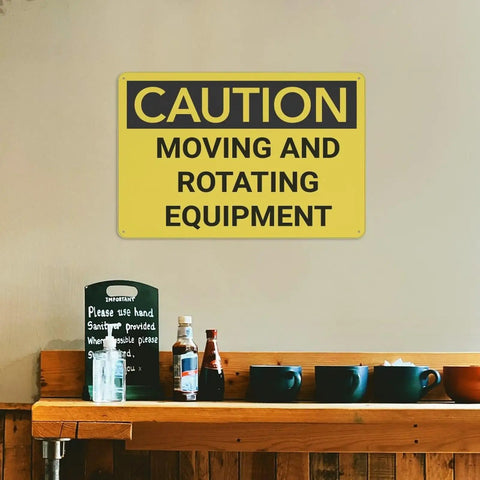 Watch Out Caution Moving And Rotating Equipment Sign on wall above shelf with mugs and bottles, rust-free aluminum.