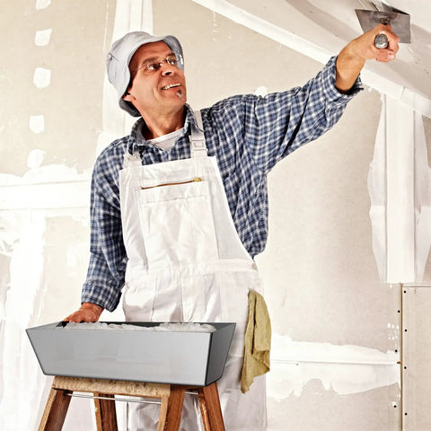 Person using Heavy Duty 12 Inch Stainless Steel Mud Pan For Drywall, Watertight Reinforced Pan With Tapered Sides for ceiling work.