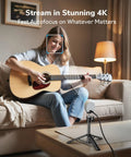 Musician streaming with Piko Dual Camera 4K AI Webcam With AI Autofocus, 3 Microphone Array And 3 Sound Modes, ideal for content creators.