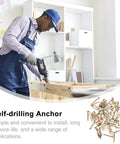 Man using drill with percussion type metal wall anchors self drilling expansion screws replacement kit for drywall and ceiling.