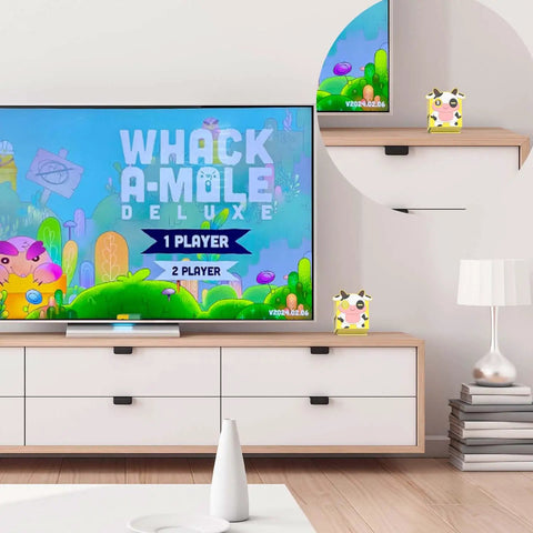 Sweet Soft Silicone Case for Nex Playground Game System on shelf beside TV, featuring colorful milk cow print, perfect for gaming.