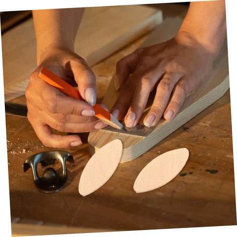 Hands using 100 PC Wood Biscuits for Woodworking Pro Grade Slotting and Plywood Joinery Tool on wooden board.