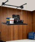 Hardcore Adjustable Overhead Garage Storage Rack With 300 Pound Capacity holding tools and paint cans in a garage setting.