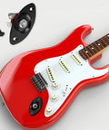 Road Ready 1/4 Mono Guitar Jack Plate Replacement Built Tough With Heavy Duty Steel Casting And Spot On 3/8 Inch Mounting Spacing and screws beside red electric guitar.