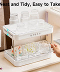 Coffee Bar Organizer Station With 2 Tier Mug Rack And Removable Drain Tray on kitchen counter with assorted glasses