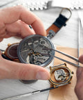 Person using tweezers to install 100Pcs Watch Battery Clamp Screws Set for micro screw replacement in watches