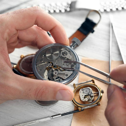Person using tweezers to install 100Pcs Watch Battery Clamp Screws Set for micro screw replacement in watches
