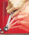 Person using Flip Wrench With 100 Gear Teeth For Precise 3.6 Degree Swings In Pro Grade Chrome Vanadium Steel on red surface