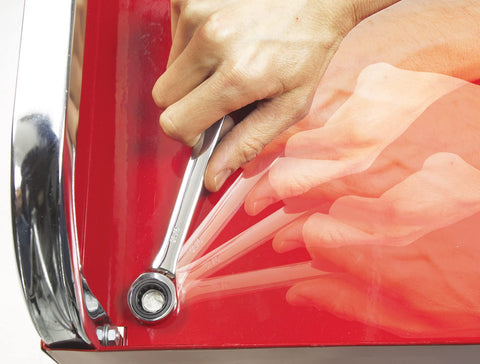Person using Flip Wrench With 100 Gear Teeth For Precise 3.6 Degree Swings In Pro Grade Chrome Vanadium Steel on red surface