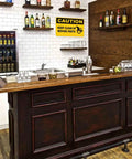 Bar area with "Caution Keep Clear Of Moving Parts" 8 by 12 inch aluminum sign on wall above sink.