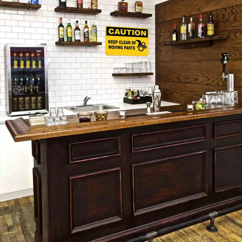 Bar area with "Caution Keep Clear Of Moving Parts" 8 by 12 inch aluminum sign on wall above sink.
