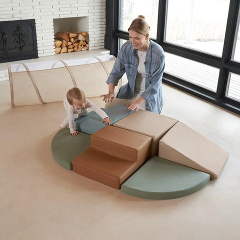 Toddler Tested Indoor Play Arena Featuring Super Soft Foam Climb Blocks, green and brown foam shapes with a toddler and adult.