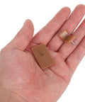 Hand holding 20 Piece Plastic And Iron Drawer Stopper Set For Dressers And Cabinets Quiet Noise Reducing Square And L Shape Glides