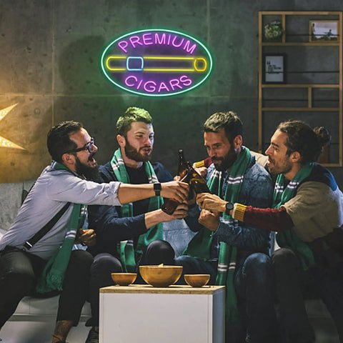 Group of friends under a neon sign reading 'Premium Cigars' sharing drinks in a lounge setting